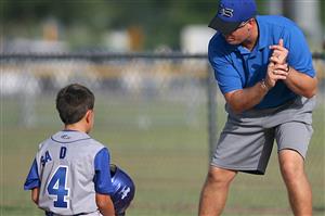 Coach showing player how to hit